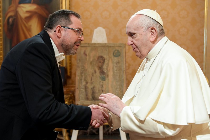 Pope Francis shakes hand with Ukraine's ambassador to the Holy See, Andrii Yurash, during a private audience at the Vatican April 7, 2022. After meeting with Pope Francis Aug. 6, Yurash said the pope planned on visiting the war-torn country before his visit to Kazakhstan in September. (CNS photo/Vatican Media via Reuters)