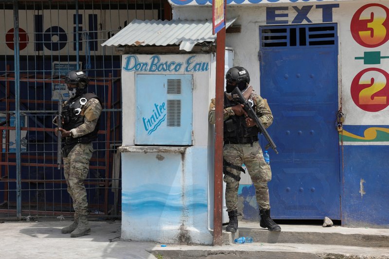 Members of the Haitian National Police patrol a street as ongoing gun battles between rival gangs forced residents to flee their homes in Port-Au-Prince April 28, 2022. Religious orders working in Haiti have called on the international community to directly intervene to address the reign of terror of armed gangs they described as "diabolical, frightening and unacceptable." (CNS photo/Ralph Tedy Erol, Reuters)