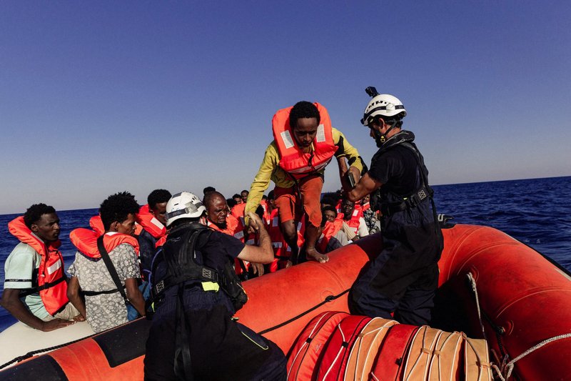 Sea-Watch crew members help a migrant boarding a rescue boat in the Mediterranean Sea July 23, 2022. African bishops are expressing "pain" at seeing young people migrate to lives of uncertainty. (CNS photo/Nora Bording, Sea-Watch handout via Reuters)