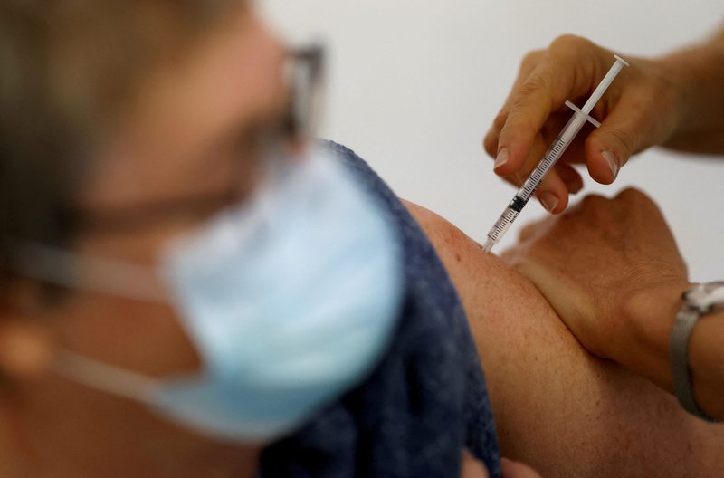 A medical worker administers a dose of the COVID-19 vaccine to a patient Nov. 17, 2021. (CNS photo/Stephane Mahe, Reuters)