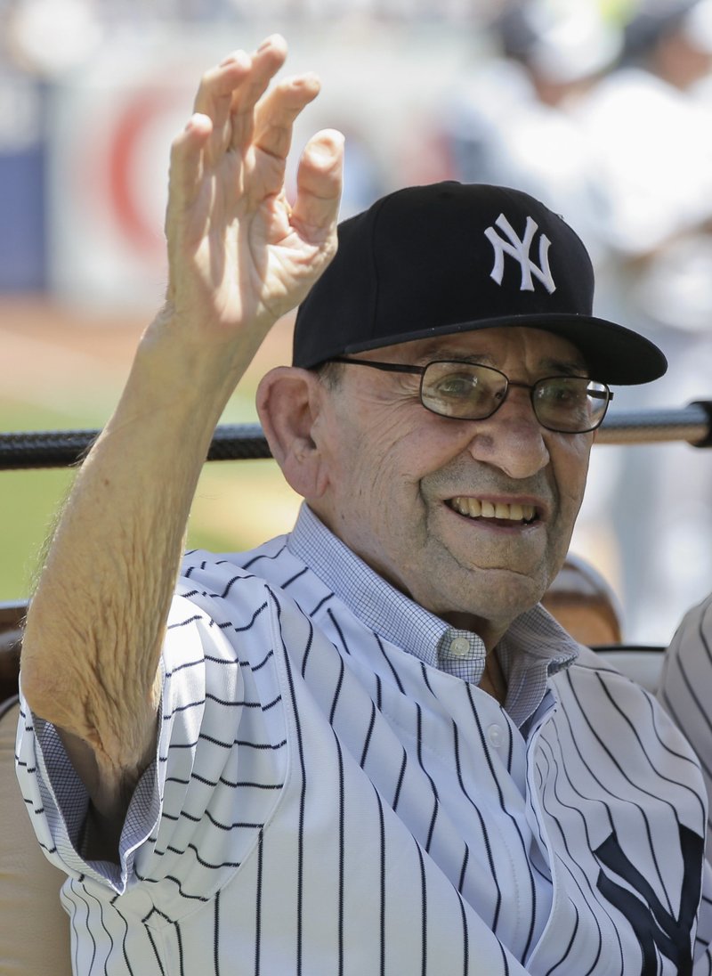 Yogi Berra waves to fans from a golf cart at Yankee Stadium in New York June 23, 2013. (CNS photo/Ray Stubblebine, Reuters)