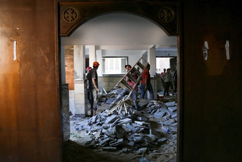 Employees start renovation work and picking up debris at Martyr Abu Sefein Coptic Orthodox Church in Imbaba, Egypt, Aug. 15, 2022, after a deadly electrical fire broke out during Sunday Mass the previous day. (CNS photo/Hanaa Habib, Reuters)