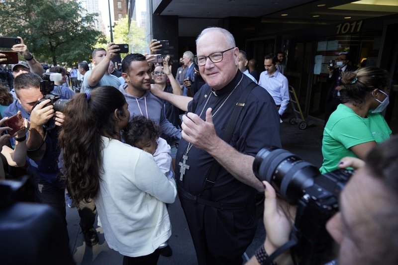 New York Cardinal Timothy M. Dolan greets a family from Venezuela seeking asylum in the U.S. prior to a news conference outside the Archdiocese of New York's headquarters in New York City Aug. 16, 2022. (CNS photo/Gregory A. Shemitz)