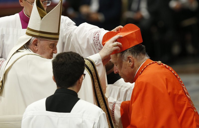 Pope Francis places a red biretta on new U.S. Cardinal Robert W. McElroy of San Diego during a consistory for the creation of 20 new cardinals in St. Peter's Basilica at the Vatican Aug. 27, 2022. (CNS photo/Paul Haring)