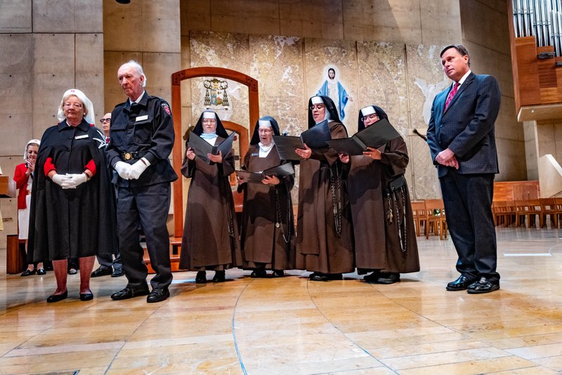 Friends of Richard and Maria Grant, including local members of the Order of Malta and of the Carmelite Sisters of the Most Sacred Heart of Los Angeles, at an Aug. 2 prayer service with the relics of St. Bernadette. The Grants were able to participate in the service via livestream. (Scott Vick)