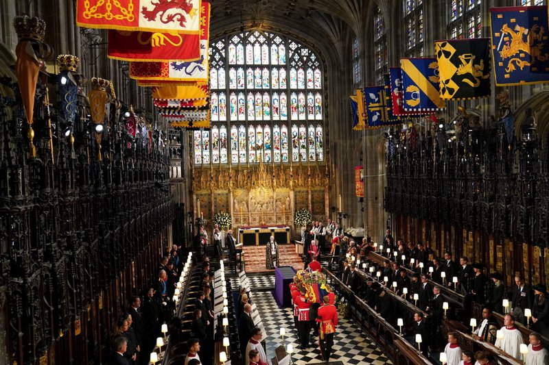The casket of Queen Elizabeth II is carried by pallbearers into the committal service at St. George's Chapel in Windsor Castle Sept. 19, 2022. (CNS photo/Joe Giddens, pool via Reuters)