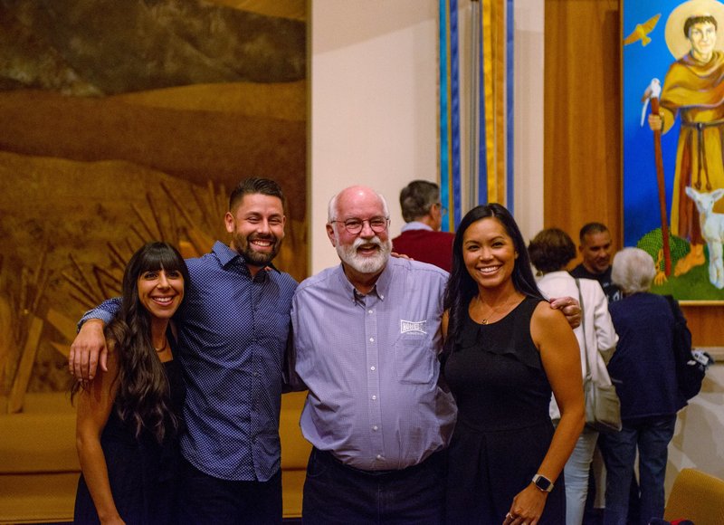 Jesuit Father Greg Boyle, founder of Homeboy Industries in Los Angeles, center, poses for a photo with Fully Liberated Youth co-founders Natalie Baddour and Preston Adams, left, and Francine Adams, Preston's wife, at Jesuit-run Regis University in Denver Sept. 9, 2022. (CNS photo/Jacob Garcia via Regis University)