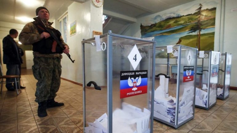 A Russian soldier stands guard at a polling station in Ukraine's Donetsk region Sept. 23, 2022. At the end of voting Sept. 27, Russia is expected to announce that the Ukrainian regions of Donetsk, Luhansk, Zaporizhzhia and Kherson voted to join Russia. (CNS photo/Ukrainian Council of Churches and Religious Organizations)