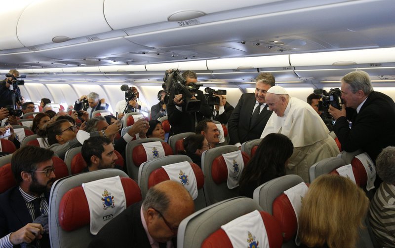 Pope Francis greets journalists aboard his flight from Rome to Nur-Sultan, Kazakhstan, Sept. 13, 2022. Pope Francis' theme for the 2023 World Communication Day will be "Speak with the heart: 'Veritatem facientes in caritate' ('Speaking truth in love')," the Vatican announced Sept. 29. (CNS photo/Paul Haring)