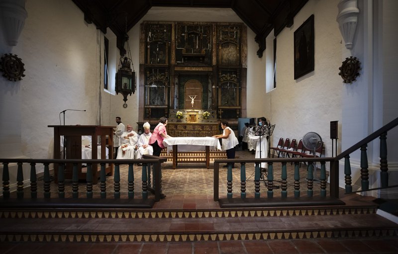 Volunteers prepare the altar at San Gabriel Mission during the Sept. 10 “Forward in Mission” jubilee closing Mass. (Victor Alemán)