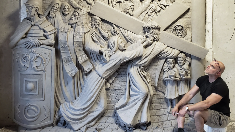 “I hope to rival Universal Studios, Walt Disney, and every other feature in Orlando by creating what has never been done before, and that is one of the biggest, most complex Stations of the Cross,” says Timothy P. Schmalz, shown here in his studio looking at the fourth station. (Courtesy of Timothy P. Schmalz via CNA)