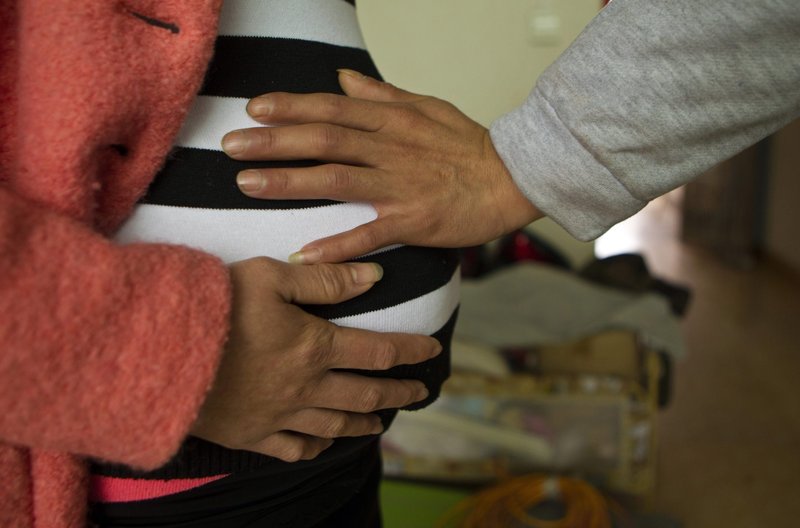 A husband and wife pose for a photo during their pregnancy. (CNS photo/Alex Lee, Reuters)
