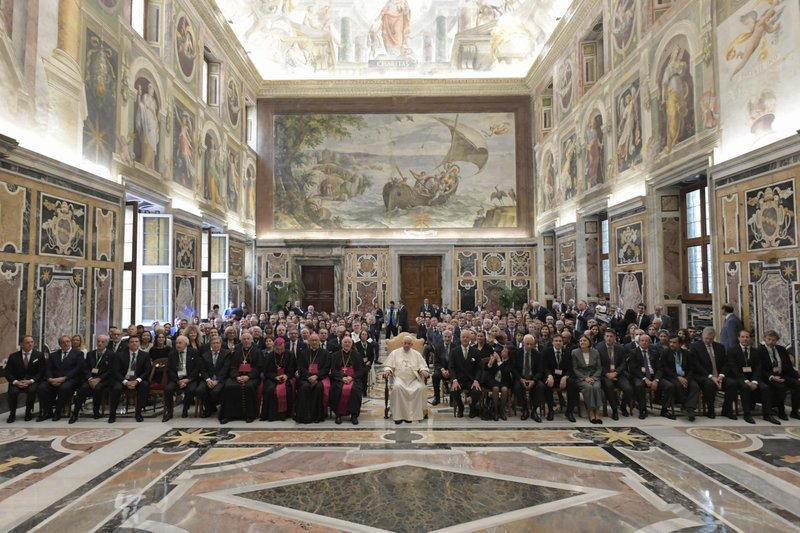 Pope Francis poses for a photo with participants in a conference sponsored by the Centesimus Annus Pro Pontifice Foundation in the Clementine Hall of the Apostolic Palace at the Vatican Oct. 8, 2022. The pope told the business leaders, theologians and scholars that job creation, not charity, is essential for promoting sustainable development. (CNS photo/Vatican Media)