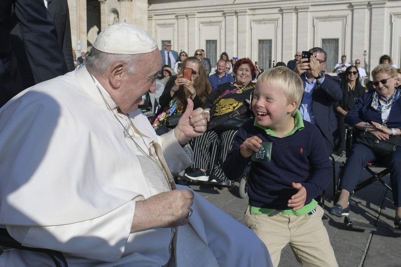 Pope Francis greets a child during his general audience in St. Peter's Square at the Vatican Oct. 12, 2022. (CNS photo/Vatican Media)