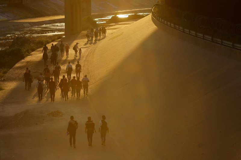 Migrants, mostly from Venezuela, walk near the border wall in El Paso, Texas, Sept. 11, 2022. (CNS photo/Jose Luis Gonzalez, Reuters)