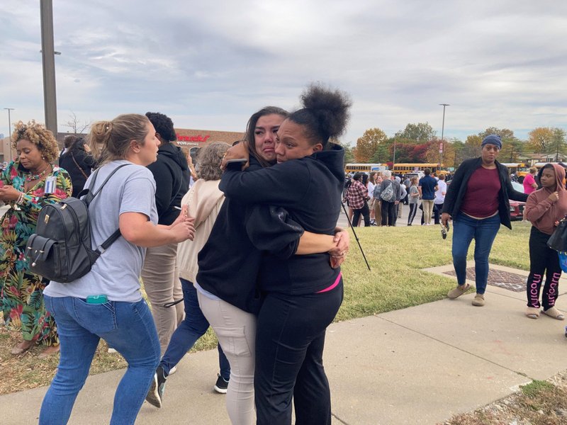 People in St. Louis embrace following a shooting at a high school Oct. 24, 2022. (CNS photo/Holly Edgell, NPR Midwest Newsroom via Reuters) EDITOR'S NOTE: NO RESALES. NO ARCHIVES. MUST DISCARD 30 DAYS AFTER DOWNLOAD.