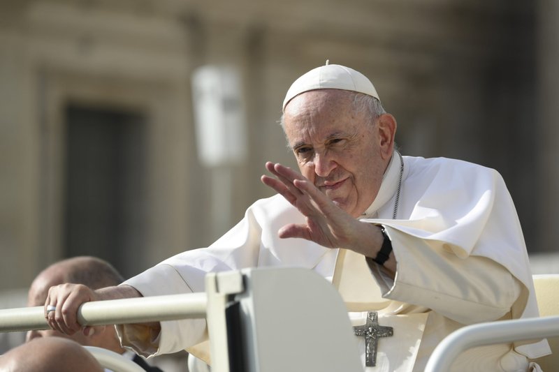 Pope Francis waves to people as he makes his way to hold his weekly general audience at the Vatican Oct. 26, 2022. (CNS photo/Vatican Media)