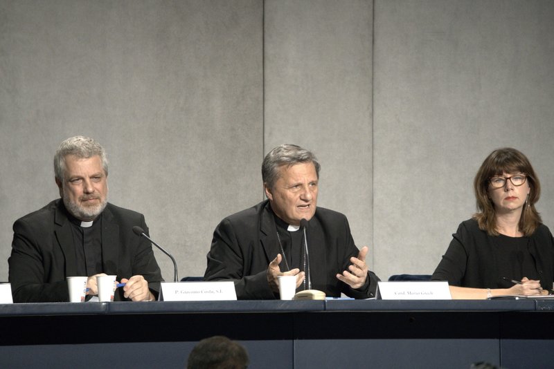 Cardinal Mario Grech, center, secretary-general of the Synod of Bishops, speaks at a news conference at the Vatican Oct. 27 to present the document for the continental phase of the Synod on synodality. Also pictured are Italian Jesuit Father Giacomo Costa, adviser to the secretary-general of the synod, and Anna Rowlands, professor of Catholic social thought and practice at Durham University in the United Kingdom. (CNS photo/Junno Arocho Esteves)