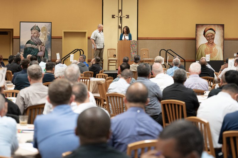 Cynthia Jones-Campbell and Father Patrick Mullen of Padre Serra parish in Camarillo address priests serving in the Archdiocese of Los Angeles at Presbyteral Day Sept. 26, 2022. (Simon Kim/Archdiocese of LA)