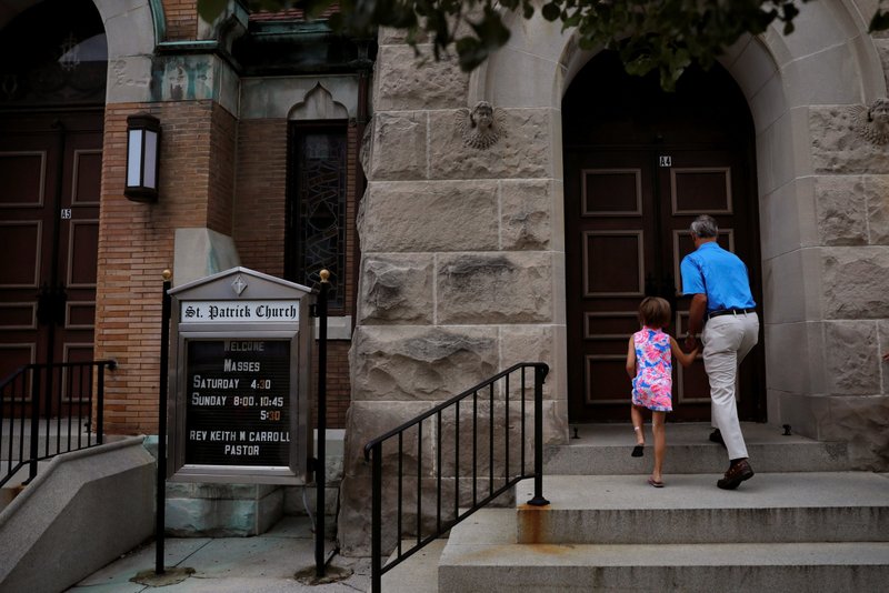 A man and child arrive for Mass at St. Patrick Church in York, Pennsylvania, in this file photo. (CNS photo/Carlos Barria, Reuters)