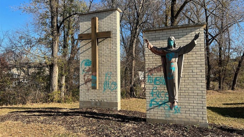 Displays of a cross and the risen Christ are seen Nov. 1, 2022, at Calvary Cemetery in Rochester, Minn., after they were desecrated by vandals Halloween night. Graves also were damaged by the vandalism, which included "hateful and obscene graffiti," said Bishop Robert E. Barron of Winona-Rochester. (CNS photo/courtesy KTTC-TV)