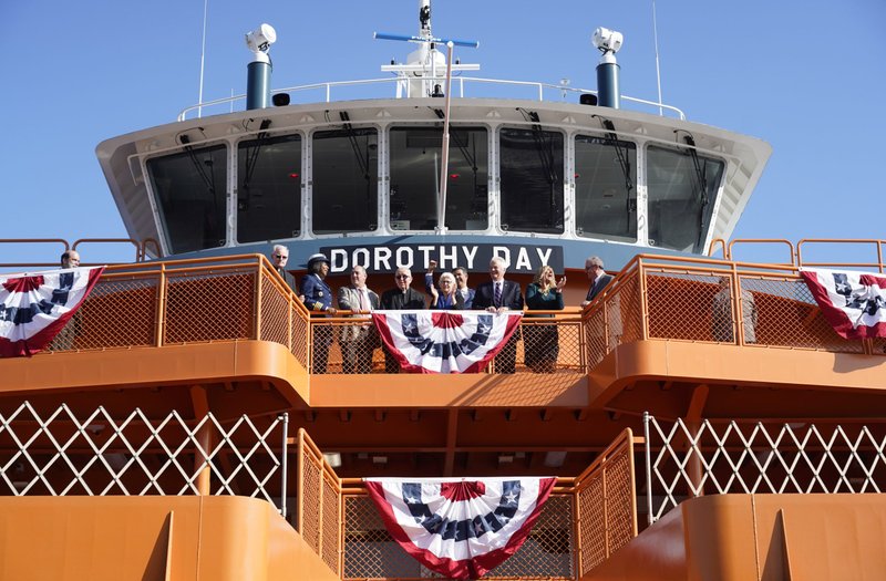 Martha Hennessy, center, granddaughter of Dorothy Day, gathers with other dignitaries during a commissioning ceremony for the Dorothy Day ferry boat, the newest vessel in the Staten Island Ferry fleet, at St. George Ferry Terminal in Staten Island, N.Y., Nov. 4, 2022. Day, co-founder of the Catholic Worker Movement, was received into the Catholic Church on Staten Island, lived part of her life in that New York City borough and is buried in the island's Resurrection Cemetery. Day is a candidate for sainthood and has the title "Servant of God." (CNS photo/Gregory A. Shemitz)