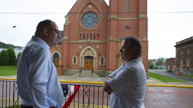 Pittsburgh resident Jim VanSickle, left, who told a Pennsylvania grand jury that he was molested by a priest when he was a teenager, speaks with former high school classmate Jack Rae of Bradford, Pa., during an Aug. 21, 2018, visit to his boyhood parish, St. Bernard Catholic Church in Bradford. (CNS photo/Chaz Muth)