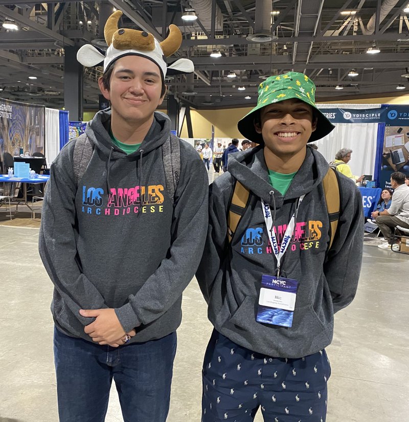 Ryan Macias (left) and Nicolas Vara, both from St. Cyril of Jerusalem in Encino, hustled for headgear at this year's NCYC. (Natalie Romano)