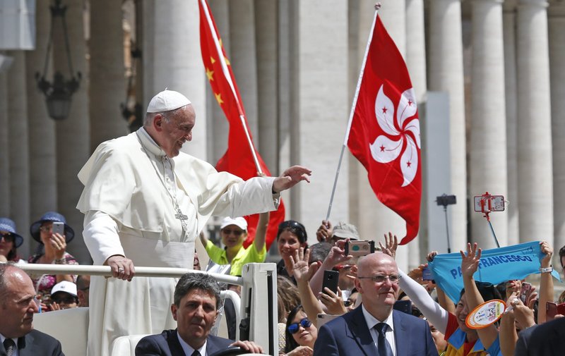 Pope Francis passes the flags of China and Hong Kong as he leaves his General Audience in St. Peter's Square at the Vatican June 12, 2019. (CNS/Paul Haring)
