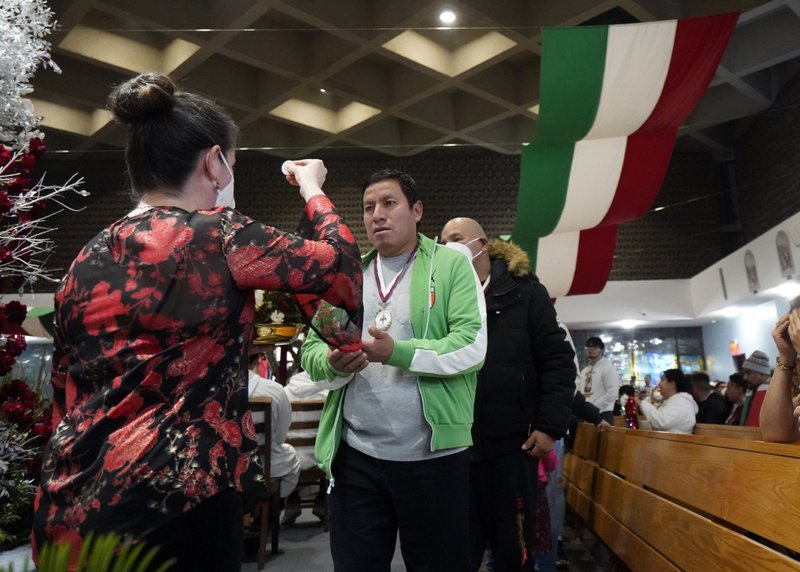 Worshippers receive Communion during a Spanish-language Mass celebrated on the eve of the feast of Our Lady of Guadalupe at Our Lady of Mount Carmel Church in Staten Island, New York, Dec. 11. (CNS/Gregory A. Shemitz)