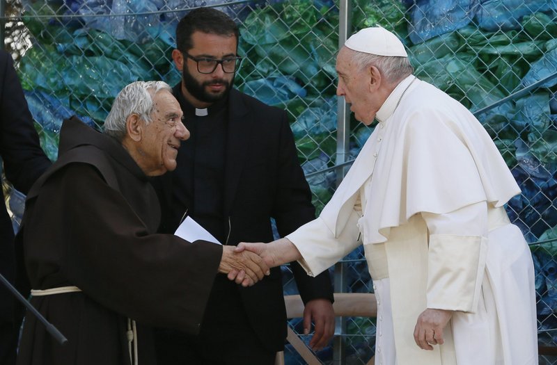 Pope Francis greets Franciscan Father Dionisio Mintoff, founder of the John XXIII Peace Lab's Center for Migrants, during a meeting with migrants at the center in Hal Far, Malta, April 3. (CNS photo/Paul Haring)