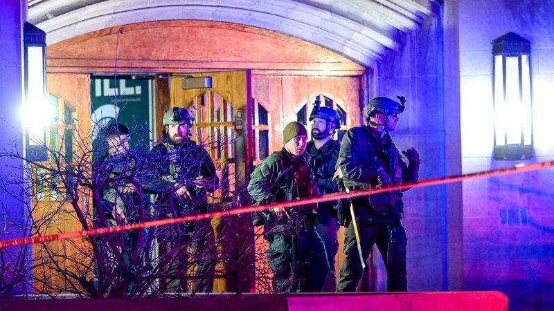 Armed Police walk around Berkey Hall after a shooting at Michigan State University in East Lansing early Feb. 14, 2023. A gunman who opened fire at the university killed at least three people and wounded five, setting off an hourslong manhunt as frightened students hid in classrooms and cars. The shooter eventually killed himself, police announced early that morning. . (OSV News photoNick King, Lansing State Journal/USA TODAY NETWORK via Reuters)
