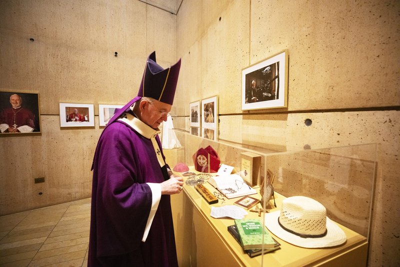 Archbishop José H. Gomez of Los Angeles pores over the items featured in the new exhibit at the Cathedral of Our Lady of the Angels honoring the late Auxiliary Bishop David O’Connell. (Victor Alemán)