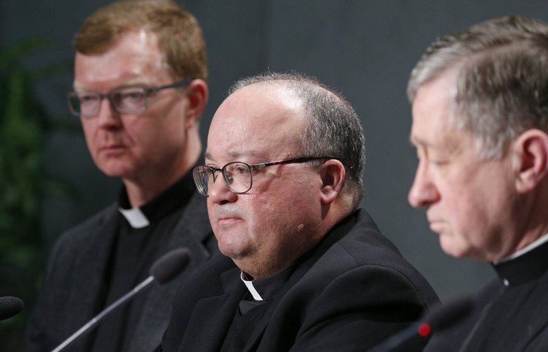 Father Hans Zollner, SJ, Archbishop Charles J. Scicluna of Malta, and Cardinal Blase J. Cupich of Chicago, all members of the organizing committee for a Vatican meeting on the protection of minors in the Church, attend a press conference in 2019. (CNS/Paul Haring)