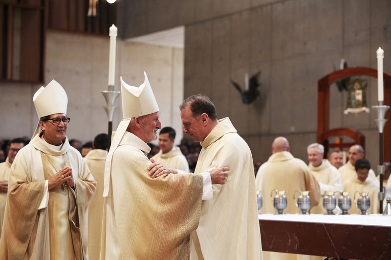 Bishop David O’Connell greets newly ordained Father Albert van der Woerd at the 2016 priest ordination Mass at the Cathedral of Our Lady of the Angels. | (Victor Alemán)