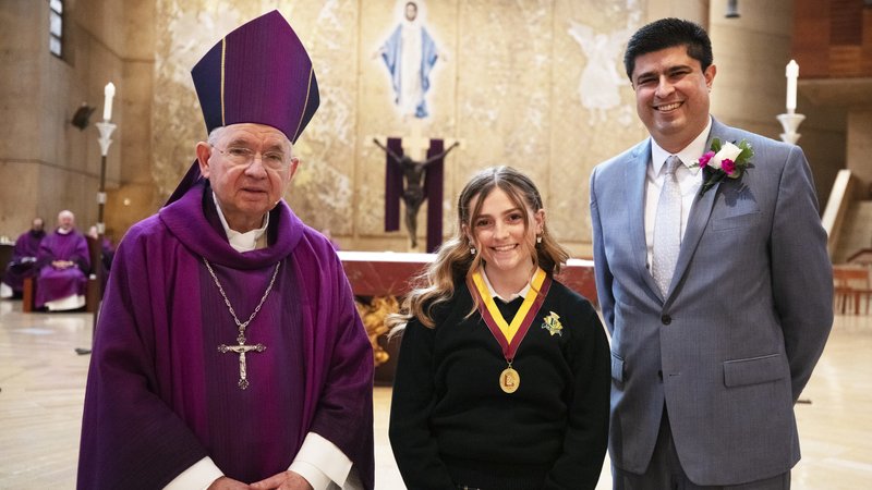 Hayley Christopher of La Reina High School in Thousand Oaks poses with Archbishop Jose H. Gomez and LA Catholic Schools superintendent Paul Escala after being honored at the annual Christian Service Awards Mass at the Cathedral of Our Lady of the Angels March 25. A total of 69 Catholic high school students and 10 teachers were honored at the Mass for their “outstanding commitment to Christian service in the community.” (Victor Alemán)