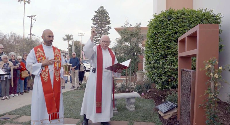 Father Leon Hutton, center, blesses the “Garden of Healing” at Our Lady of the Assumption Church in Ventura. The garden is the second one in the Archdiocese of Los Angeles and was designed for those suffering from Church abuse and trauma. (John Rueda)