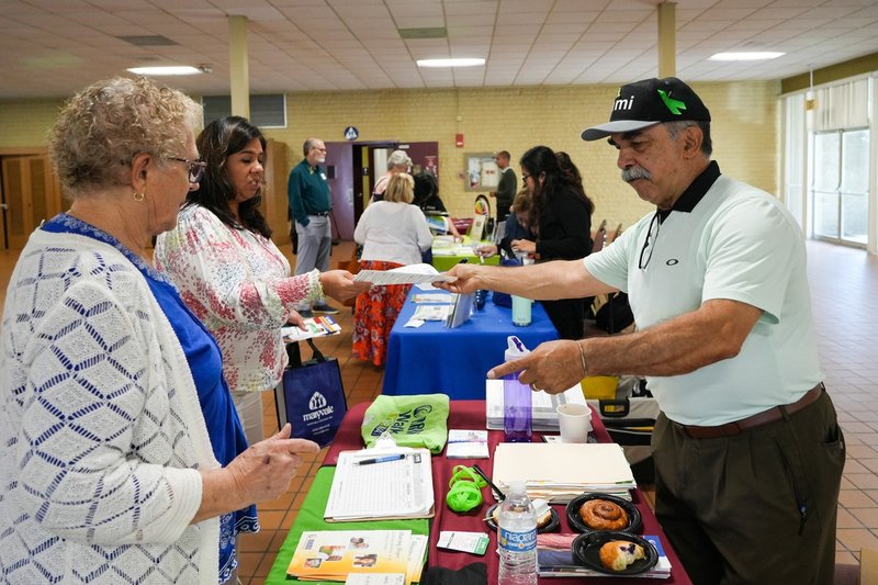Rick Pulido of the National Alliance on Mental Illness (NAMI)’s South Bay chapter shares informational materials at the May 18 workshop. (Stefano Garzia)