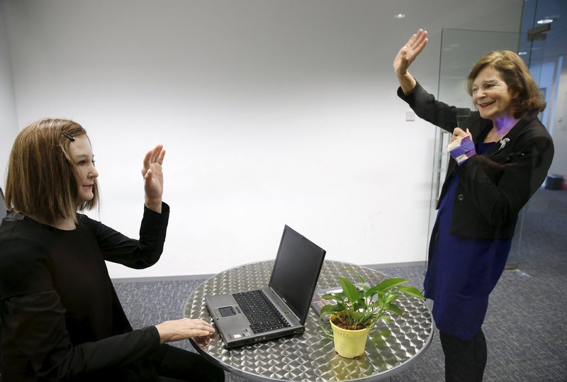 Nadia Thalmann, right, a professor at Nanyang Technological University in Singapore, talks to a humanoid March 1 that she and her team created. With her brown hair, soft skin and expressive face, the humanoid is a new brand of robot that could one day, scientists hope, be used as a personal assistant or care provider for the elderly. (CNS/Edgar Su, Reuters)