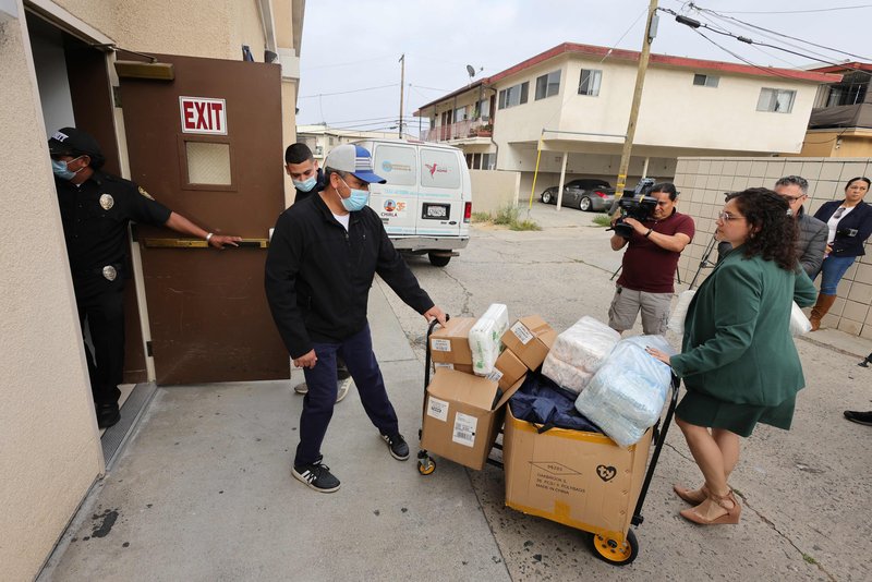 Officials and volunteers deliver diapers, supplies, and toys to St. Anthony Croatian Catholic Church, where a busload of migrants were transported on June 14, 2023 after arriving at Union Station in Los Angeles from Texas as claimed by Gov. Greg Abbott. (David Swanson/AFP via Getty Images)