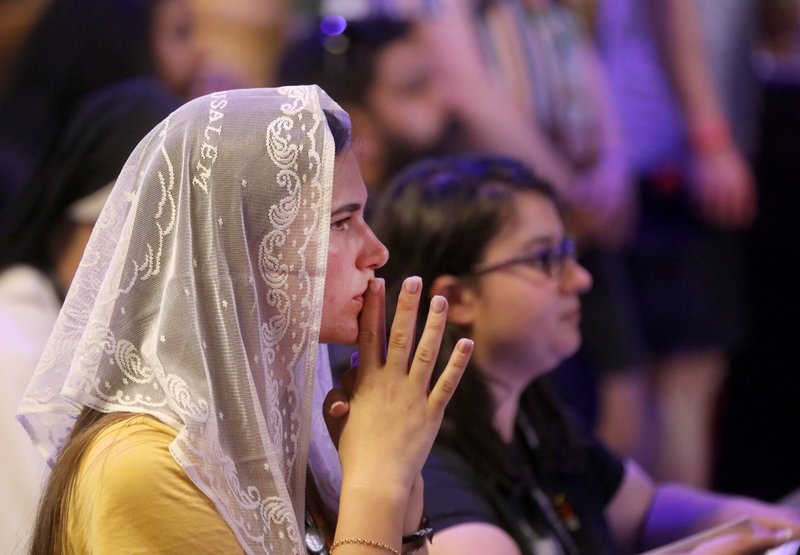 A young Australian World Youth Day pilgrim prays during Mass at the Church of Our Lady of the Rosary of Fátima in Lisbon, Portugal, July 31. (OSV News/Bob Roller)
