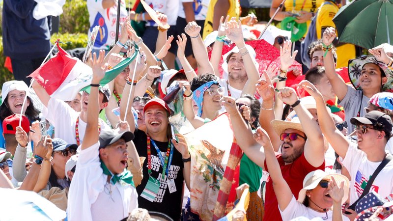 Young people cheer before the World Youth Day Stations of the Cross service presided over by Pope Francis at Eduardo VII Park in Lisbon, Portugal, Aug. 4, 2023. (CNS photo/Lola Gomez)