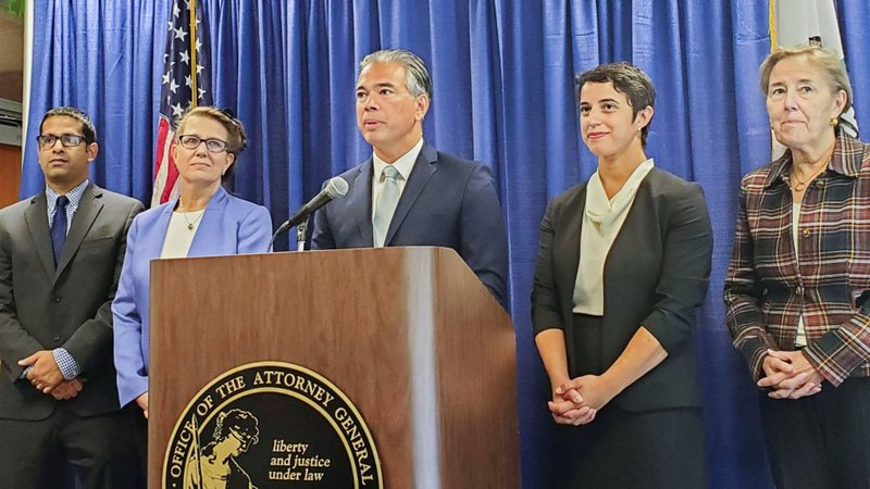 California Attorney General Rob Bonta, at lectern and flanked by staff in a file photo from Sept. 14, 2022. On Aug. 28, 2023 Bonta announced that the state is bringing suit to stop a San Bernardino school district from carrying out a policy of informing parents when their child requests to change their gender and pronouns. (OSV News photo/Paresh Dave, Reuters)