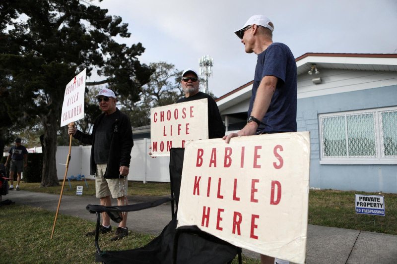 Anti-abortion rights activists stand outside of the Bread and Roses Woman's Health Center, a clinic that provides abortions while women arrive to receive patient care in Clearwater, Fla., February 11, 2023. (REUTERS/Octavio Jones/File Photo)