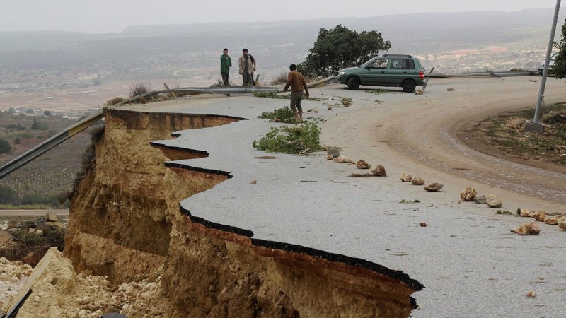 People stand in a damaged road as a powerful storm and heavy rainfall flooded hit Shahhat city, Libya, Sept. 11, 2023. At least 2,000 people have died and 10,000 are believed missing after Storm Daniel dumped so much rain on Libya’s northeast that two dams collapsed sending water flowing into already inundated areas. (OSV News/Omar Jarhman, Reuters)