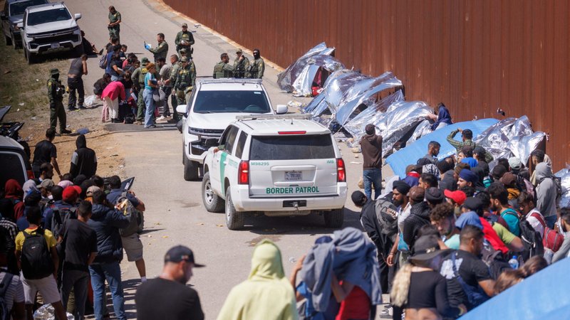 U.S. Border Patrol officers work to sort out migrants gathered between the primary and secondary border fences at the U.S.-Mexico border just south of San Diego Sept.12, 2023. (OSV News/Mike Blake, Reuters)