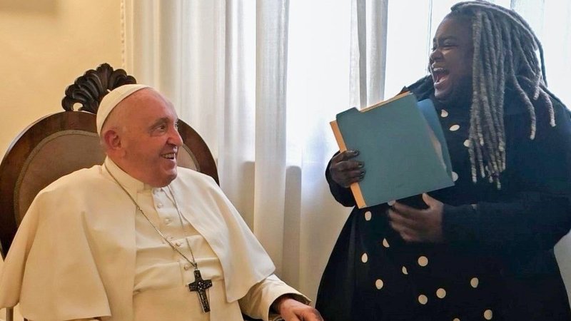 Pope Francis shares a laugh with Tazamisha Alexander, a leader with Common Ground in Solano Country, Calif., a group affiliated with the West/Southwest Industrial Areas Foundation, in his Vatican residence, the Domus Sanctae Marthae, Sept. 14, 2023. (CNS/Courtesy of West/Southwest Industrial Areas Foundation)