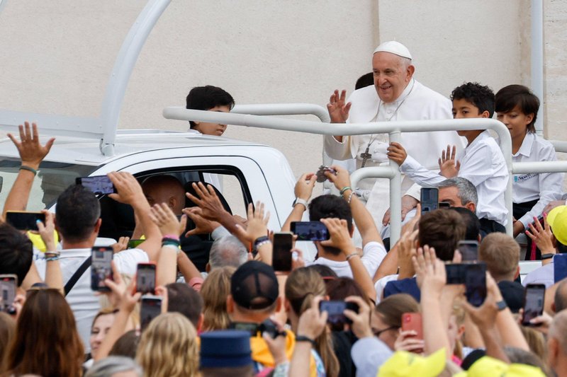 Pope Francis greets visitors from the popemobile as he rides around St. Peter's Square at the Vatican before his weekly general audience Sept. 20, 2023. (CNS photo/Lola Gomez)