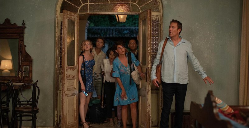 Ian, played by John Corbett (left), with characters from “My Big Fat Greek Wedding 3” in a scene from the 2023 film. (Courtesy of Yannis Drakoulidis - © 2023 Focus Features, LLC)