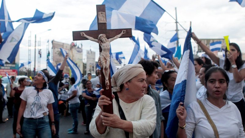 A demonstrator holds a crucifix during a protest against Nicaraguan President Daniel Ortega's government in Managua May 15, 2018. (OSV News photo/Oswaldo Rivas, Reuters)
